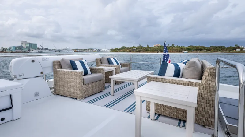 Slide: The Image of Luxurious outdoor seating on 2018 Ocean Alexander 85 E yacht, overlooking serene waters. - 47
