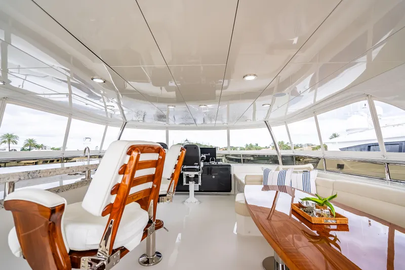 Slide: The Image of Luxurious interior of 2018 Ocean Alexander 85 E yacht with elegant seating and polished wood table. - 49