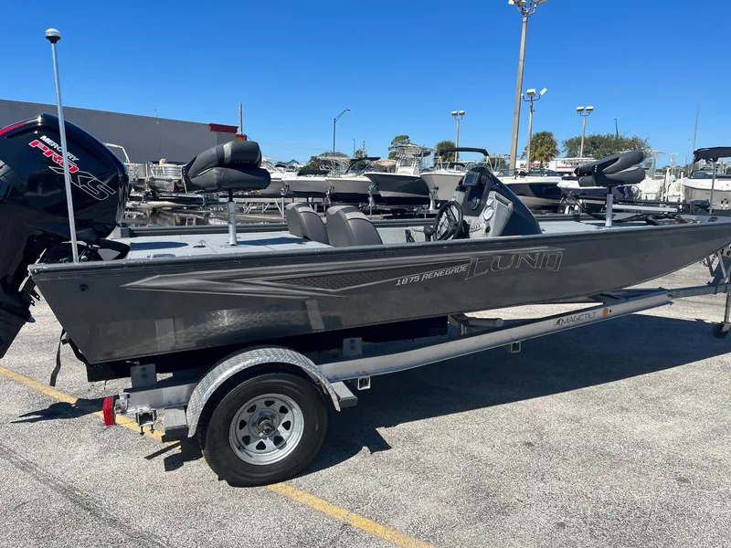 Slide: The Image of 2020 Lund 1875 Predator fishing boat on a trailer in a parking lot. - 3