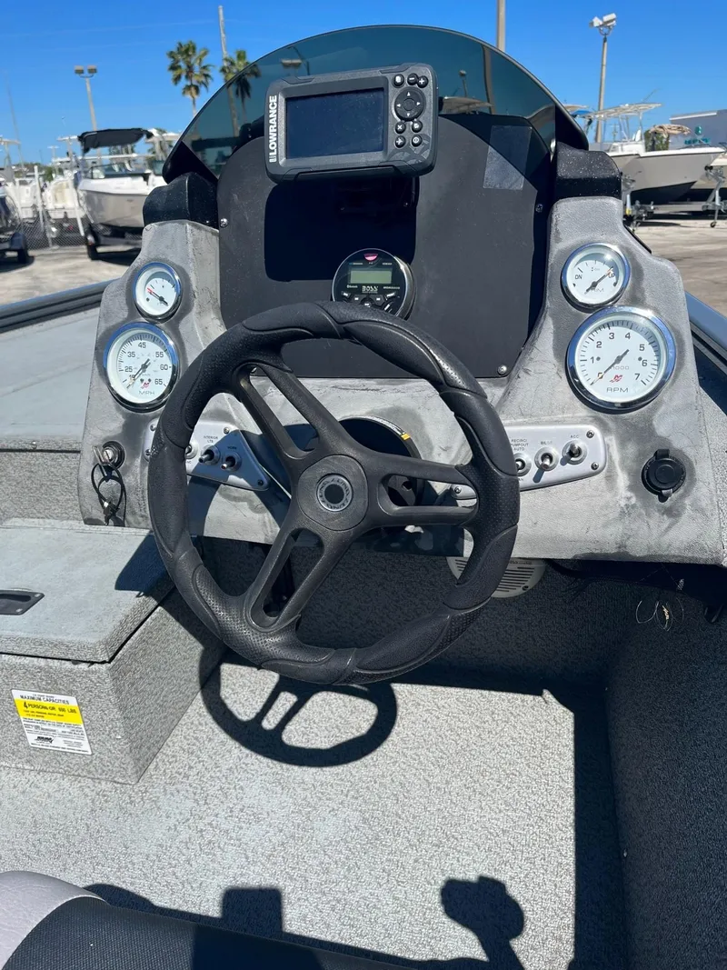 Slide: The Image of 2020 Lund 1875 Predator boat dashboard with steering wheel and gauges. - 4