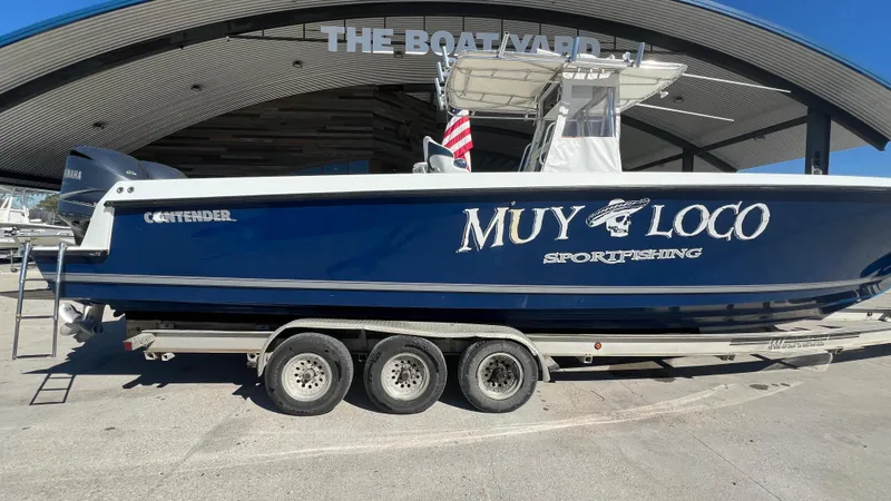 Slide: The Image of 2005 Contender 36 Open boat on a trailer at a marina. - 2