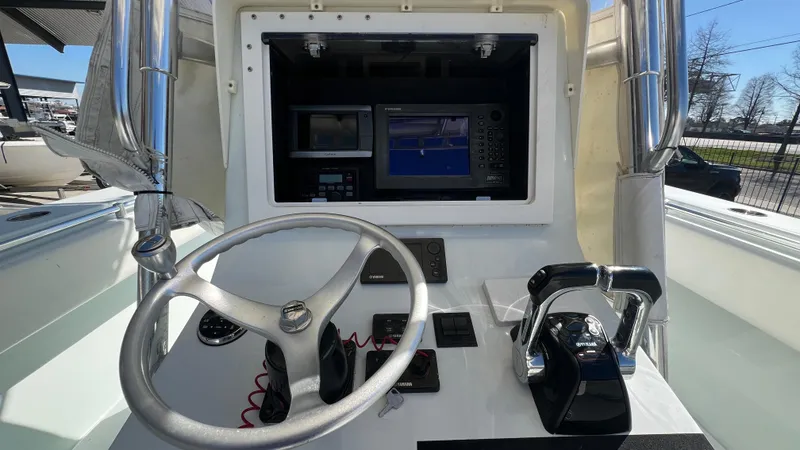 Slide: The Image of 2005 Contender 36 Open boat helm with steering wheel, throttle, and navigation system. - 9