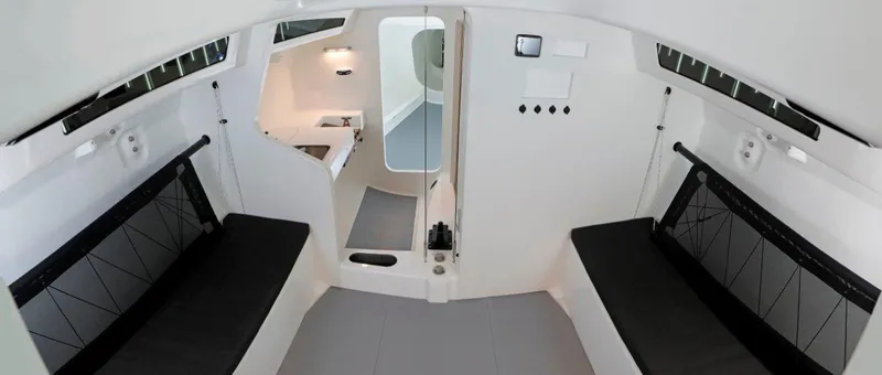 Slide: The Image of Modern interior of 2024 M.A.T. 1220 sailboat with black seating and white walls. - 10