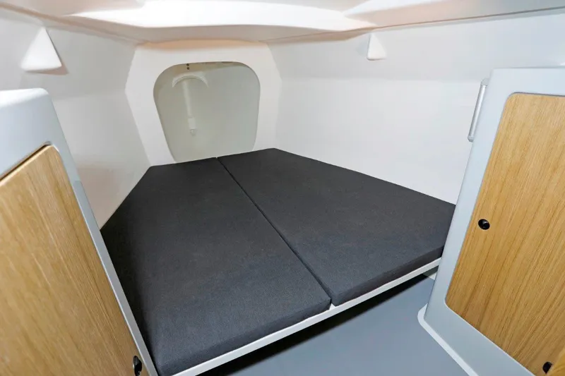 Slide: The Image of 2024 M.A.T. 1220 boat interior cabin with cushioned sleeping area. - 12