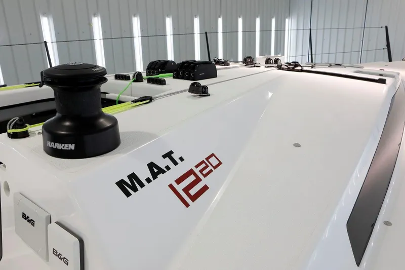 Slide: The Image of M.A.T. 1220 sailboat deck, 2024 model, featuring Harken equipment. - 4