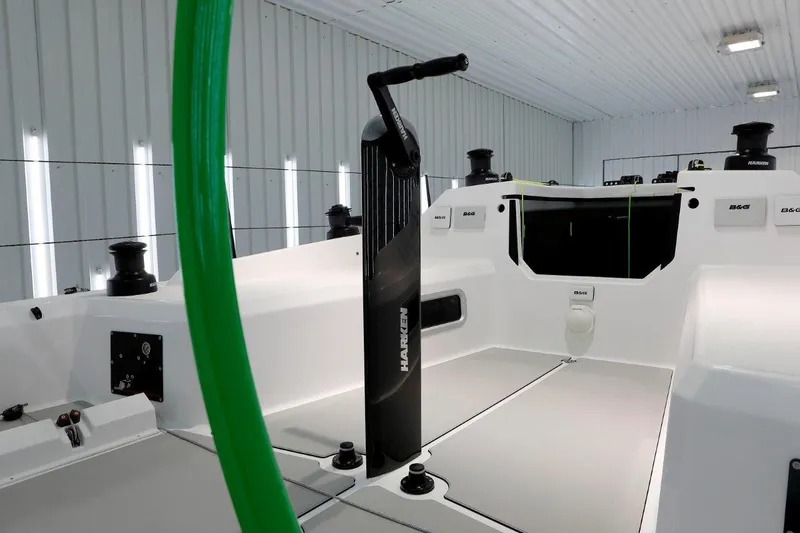 Slide: The Image of 2024 M.A.T. 1220 sailboat cockpit with modern steering column in a well-lit indoor setting. - 5