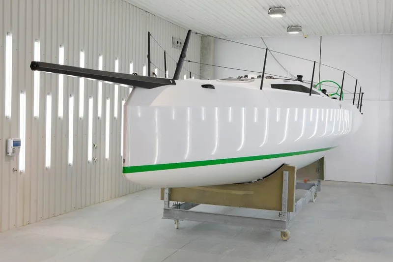 Slide: The Image of 2024 M.A.T. 1220 sailboat in a well-lit indoor facility. - 7