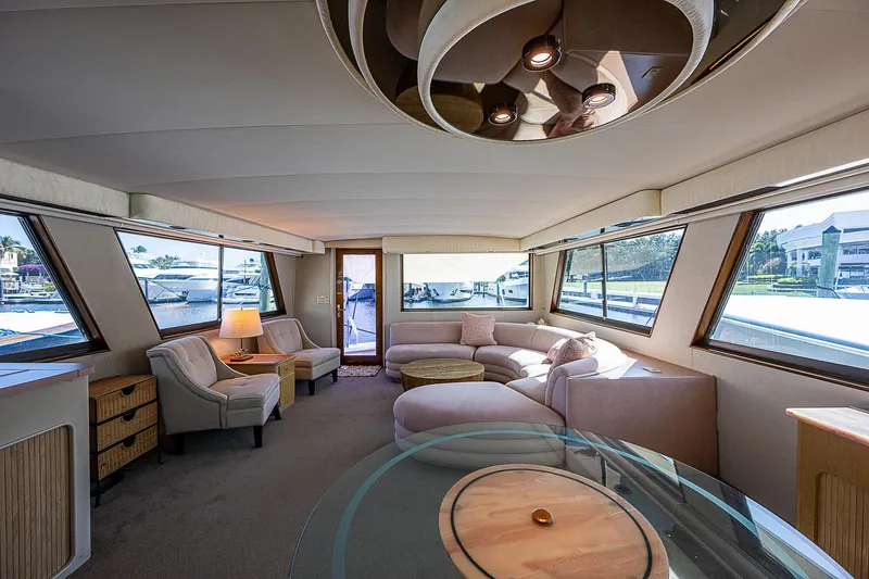 Slide: The Image of Luxurious interior of 1986 Hatteras 72 Motor Yacht with elegant seating and panoramic windows. - 13