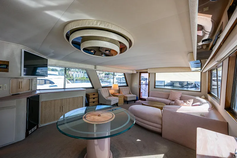 Slide: The Image of Interior of 1986 Hatteras 72 Motor Yacht with modern furnishings and large windows. - 14