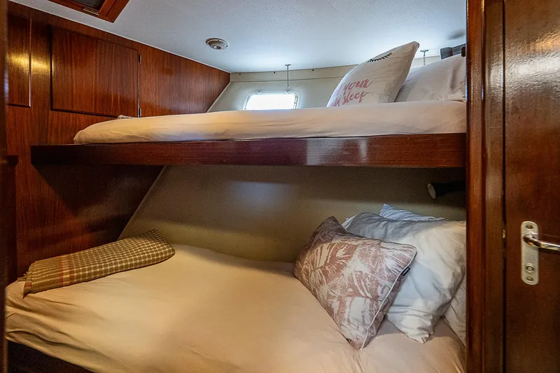 Slide: The Image of Cozy bunk beds in 1986 Hatteras 72 Motor Yacht cabin with wooden interior. - 16