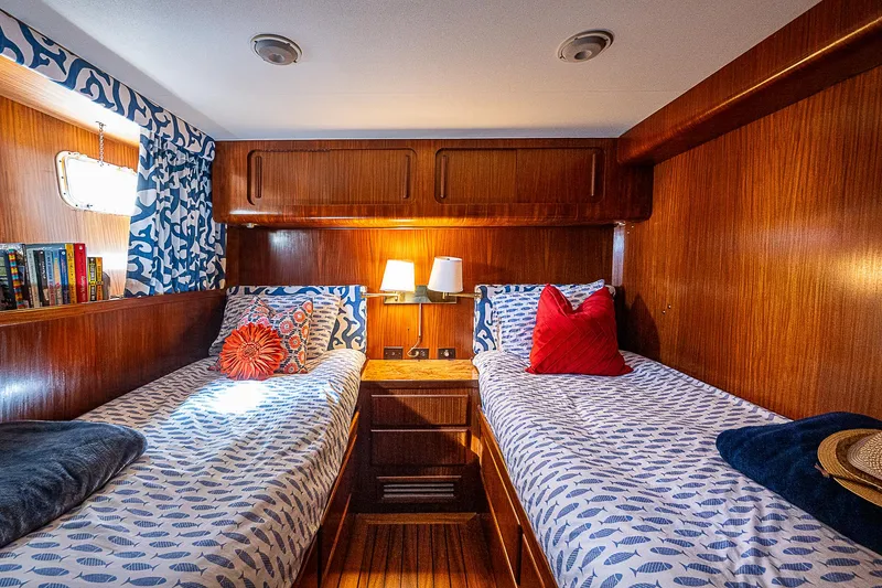 Slide: The Image of Cozy twin cabin in 1986 Hatteras 72 Motor Yacht with wood paneling and nautical decor. - 20