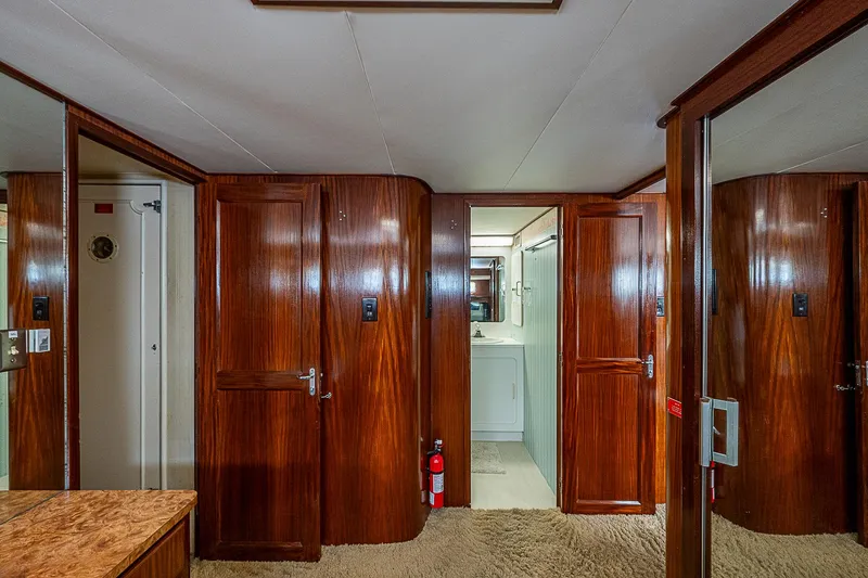 Slide: The Image of Interior of 1986 Hatteras 72 Motor Yacht with wooden doors and carpeted floor. - 22