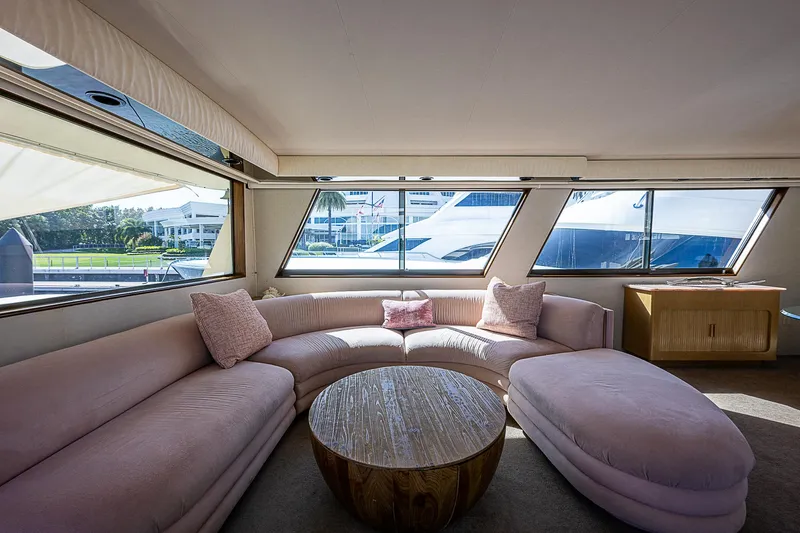 Slide: The Image of Luxurious interior of 1986 Hatteras 72 Motor Yacht with plush seating and large windows. - 24