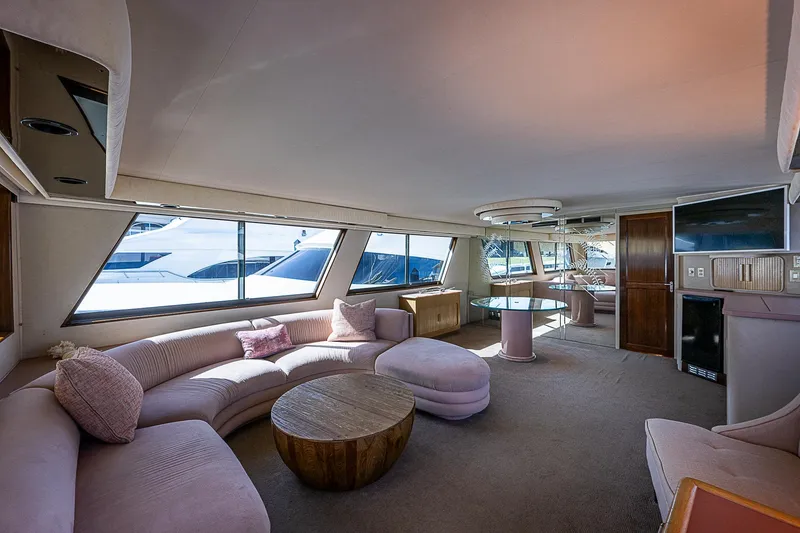 Slide: The Image of Luxurious interior of 1986 Hatteras 72 Motor Yacht with plush seating and modern decor. - 25