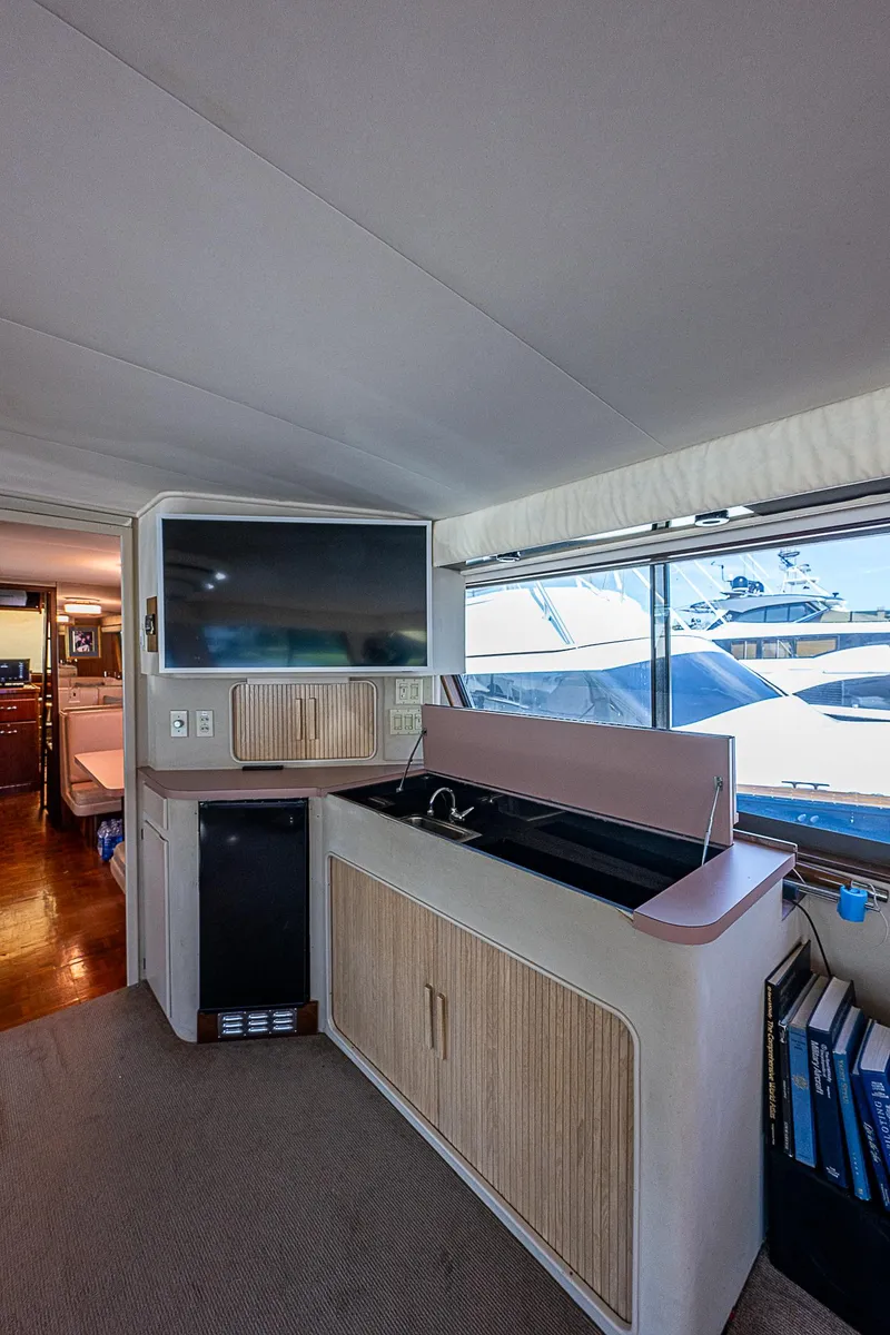 Slide: The Image of Interior of 1986 Hatteras 72 Motor Yacht with TV and cabinetry. - 27