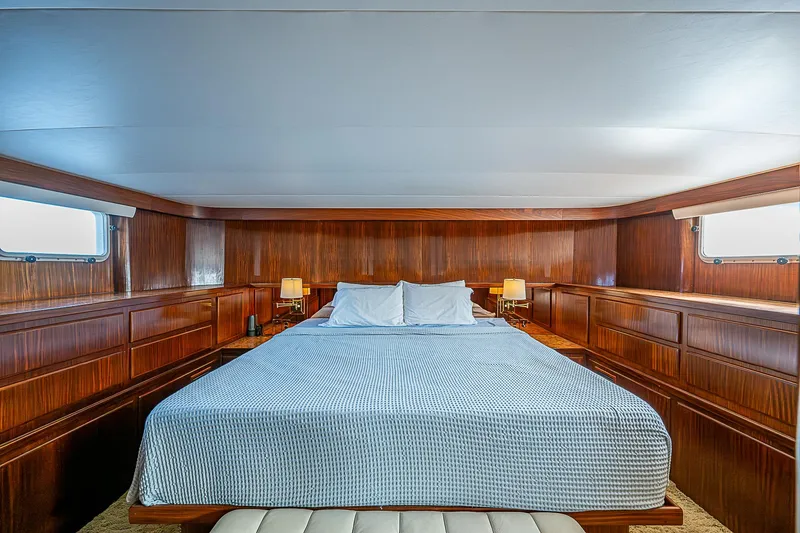 Slide: The Image of Luxurious bedroom interior of 1986 Hatteras 72 Motor Yacht with wood paneling and large bed. - 29