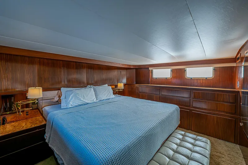 Slide: The Image of Luxurious bedroom interior of 1986 Hatteras 72 Motor Yacht with wood paneling and large bed. - 30