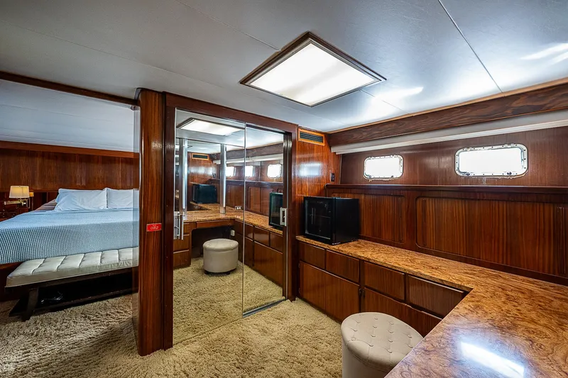 Slide: The Image of Luxurious 1986 Hatteras 72 Motor Yacht bedroom with wood paneling and mirrored closet. - 31