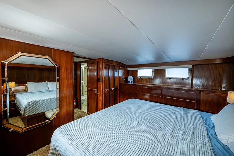 Slide: The Image of Luxurious bedroom interior of 1986 Hatteras 72 Motor Yacht with wood paneling. - 33