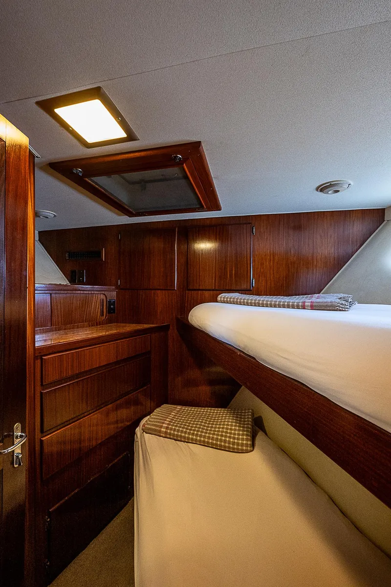 Slide: The Image of Cozy cabin interior of 1986 Hatteras 72 Motor Yacht with wooden furnishings. - 37
