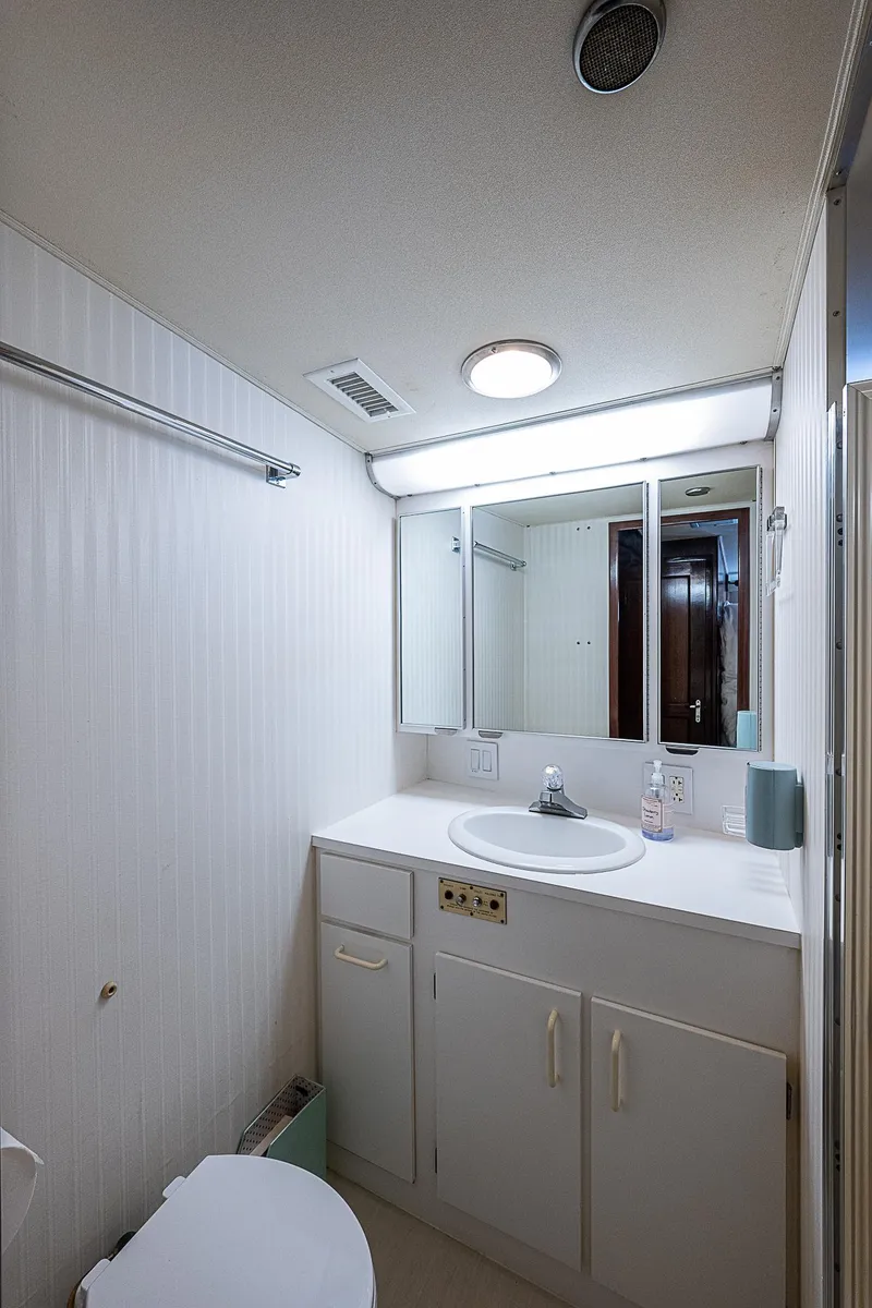 Slide: The Image of Bathroom interior of 1986 Hatteras 72 Motor Yacht, featuring sink and mirror. - 40