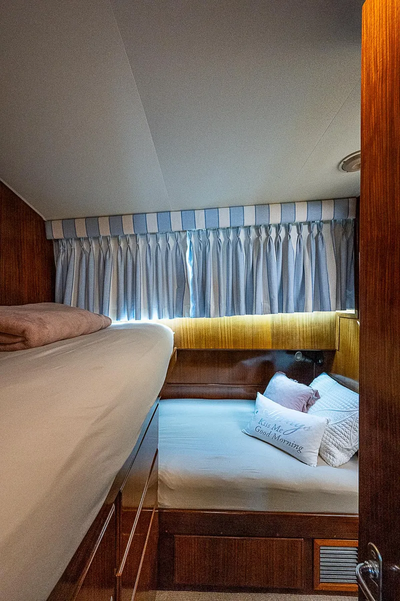 Slide: The Image of Cozy bedroom in 1986 Hatteras 72 Motor Yacht with striped curtains and plush bedding. - 45
