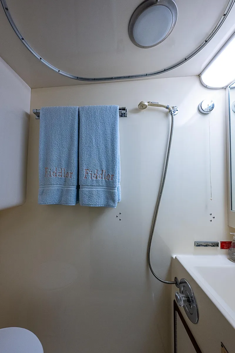 Slide: The Image of Bathroom in 1986 Hatteras 72 Motor Yacht with blue towels and showerhead. - 48