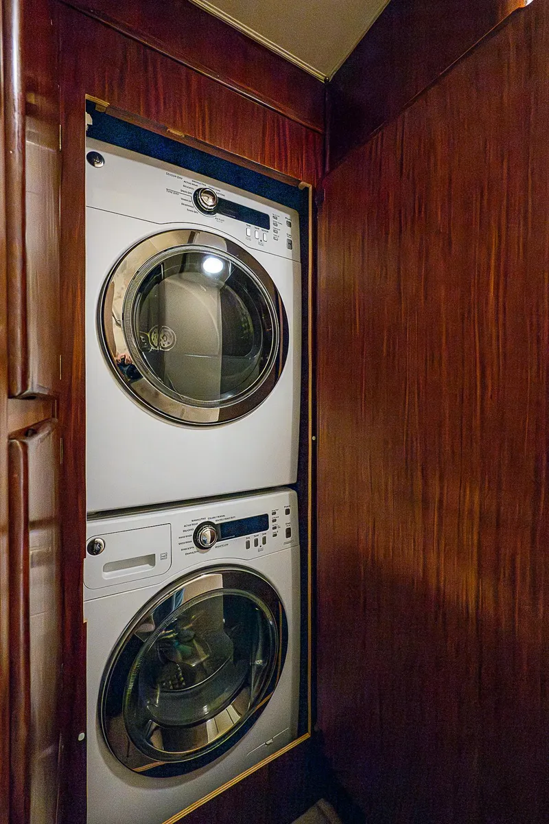 Slide: The Image of Stacked washer and dryer in 1986 Hatteras 72 Motor Yacht with wooden paneling. - 49