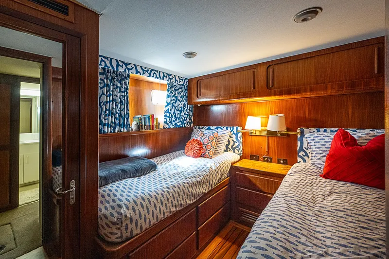 Slide: The Image of Cozy twin bedroom in 1986 Hatteras 72 Motor Yacht with wooden accents and patterned bedding. - 50