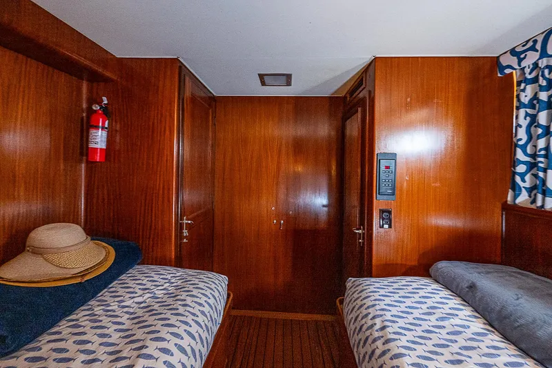 Slide: The Image of Interior cabin of 1986 Hatteras 72 Motor Yacht with twin beds and wooden paneling. - 52