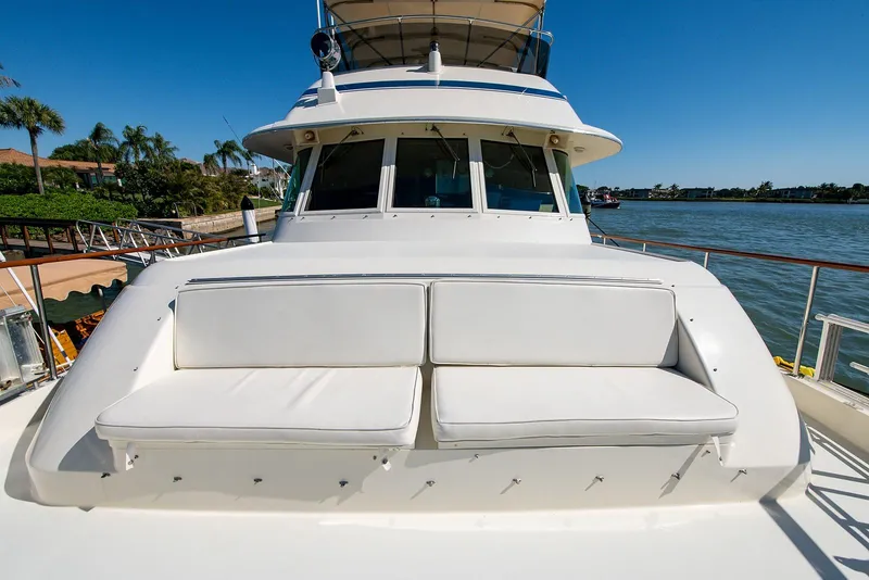 Slide: The Image of 1986 Hatteras 72 Motor Yacht with white cushioned seating on deck. - 6