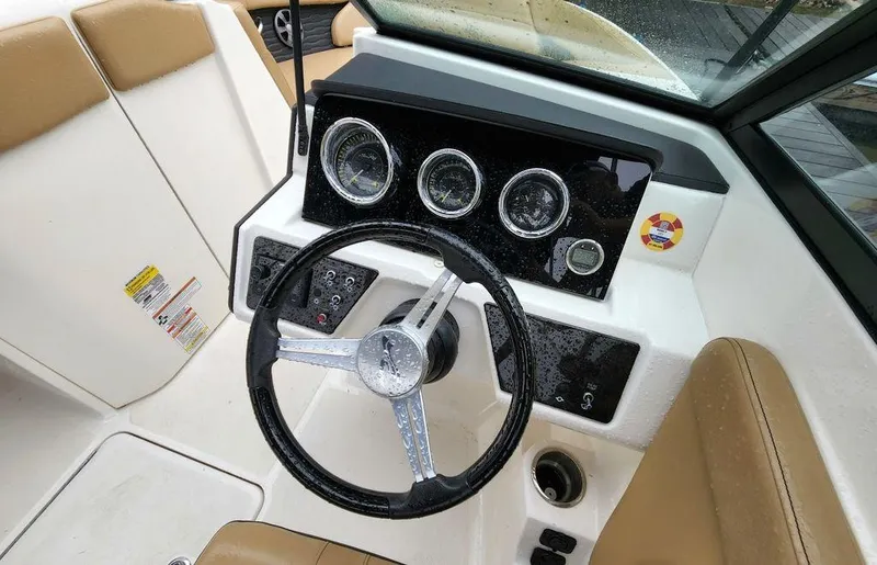 Slide: The Image of 2021 Sea Ray 230 SPXO boat dashboard with steering wheel and instrument panel. - 4