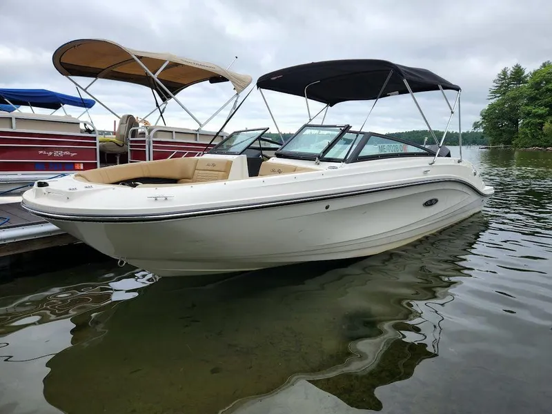 Slide: The Image of 2021 Sea Ray 230 SPXO boat docked on a calm lake. - 7