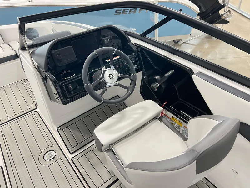 Slide: The Image of 2024 Yamaha Boats 195 S cockpit with steering wheel and modern dashboard. - 2