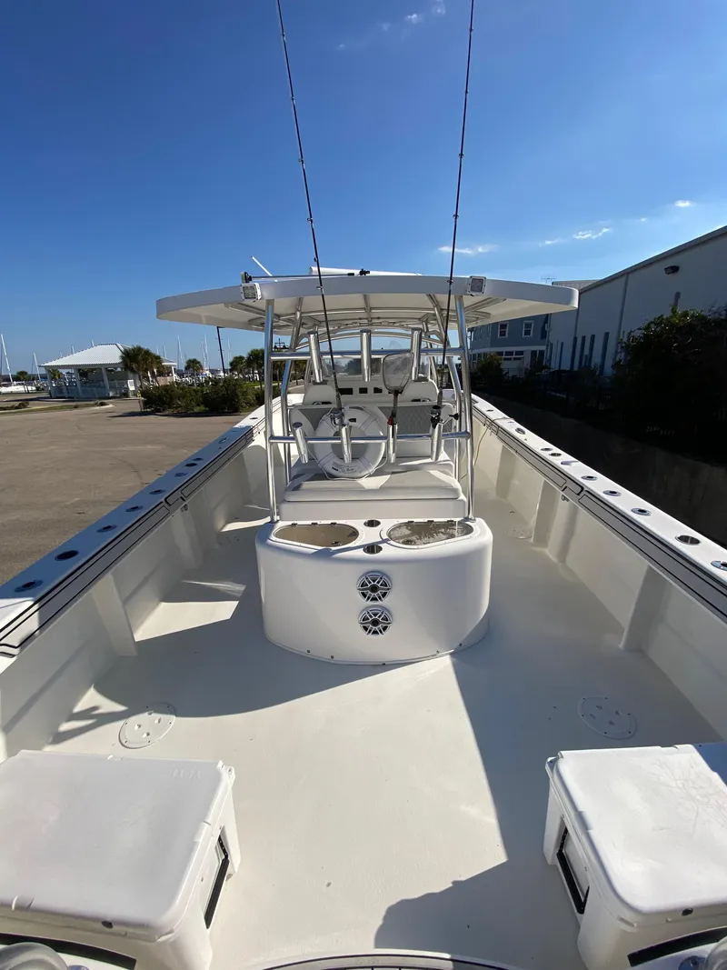 Slide: The Image of 2021 Twin Vee 36 Center Console boat with spacious deck and seating, under clear blue sky. - 11