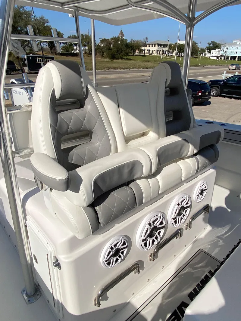 Slide: The Image of 2021 Twin Vee 36 Center Console boat with dual cushioned seats and built-in speakers. - 14