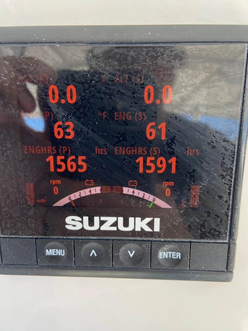 Slide: The Image of Suzuki engine display on 2021 Twin Vee 36 Center Console boat, showing engine hours and RPM. - 28