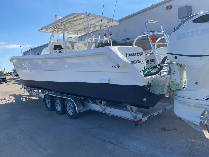 Slide: The Image of 2021 Twin Vee 36 Center Console boat on trailer, featuring dual outboard engines. - 30