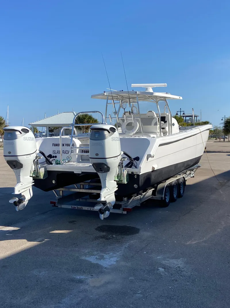 Slide: The Image of 2021 Twin Vee 36 Center Console boat with dual outboard engines on a trailer. - 32