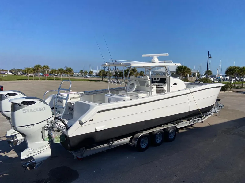 Slide: The Image of 2021 Twin Vee 36 Center Console boat with dual Suzuki engines on a trailer. - 33