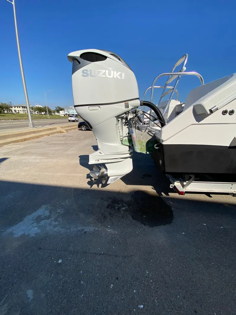 Slide: The Image of 2021 Twin Vee 36 Center Console with Suzuki outboard motor, parked on a sunny day. - 4