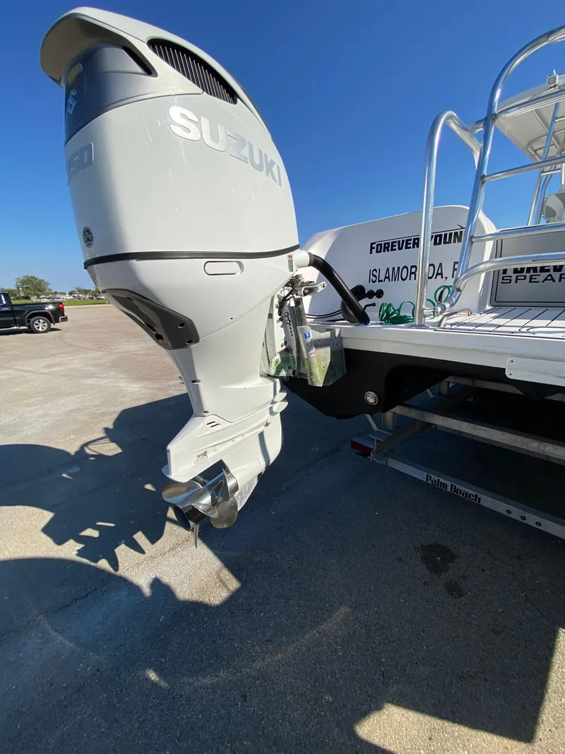 Slide: The Image of 2021 Twin Vee 36 Center Console with Suzuki outboard motor in a sunny marina. - 7
