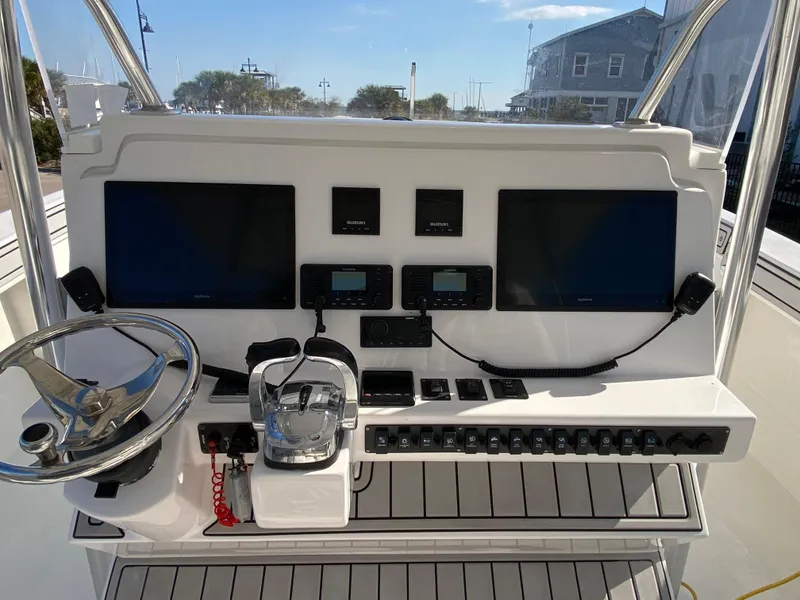 Slide: The Image of 2021 Twin Vee 36 Center Console boat dashboard with dual screens and controls. - 9