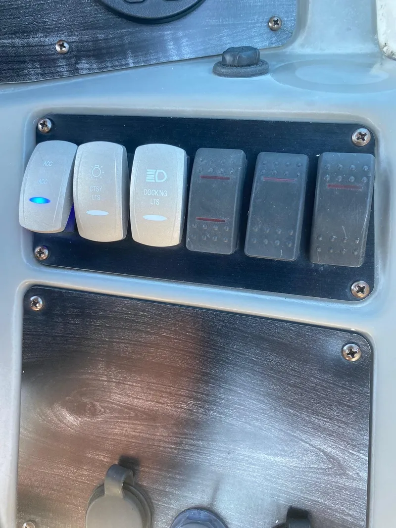 Slide: The Image of Control panel switches on a 2017 Hurricane SunDeck 2200 DC OB boat. - 10