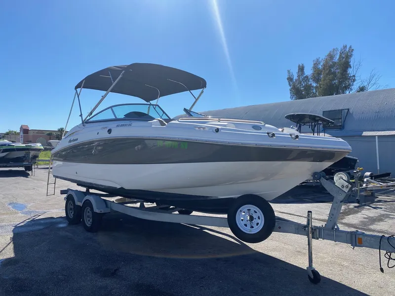 Slide: The Image of 2017 Hurricane SunDeck 2200 DC OB boat on a trailer under a clear blue sky. - 2