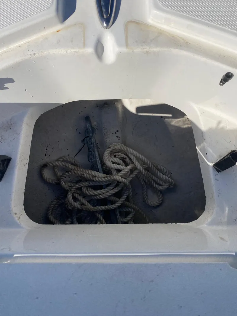 Slide: The Image of 2017 Hurricane SunDeck 2200 DC OB boat storage compartment with coiled rope. - 23