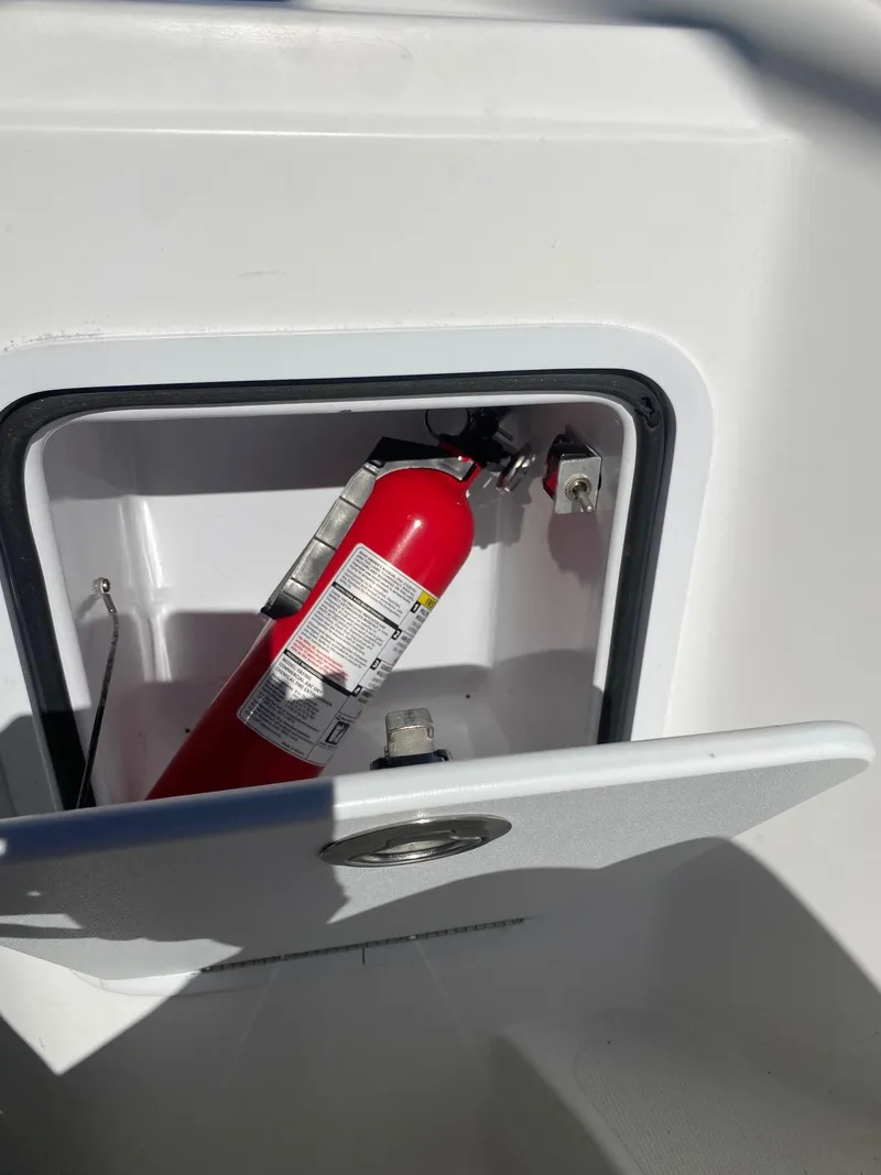 Slide: The Image of Fire extinguisher compartment on a 2017 Hurricane SunDeck 2200 DC OB boat. - 29