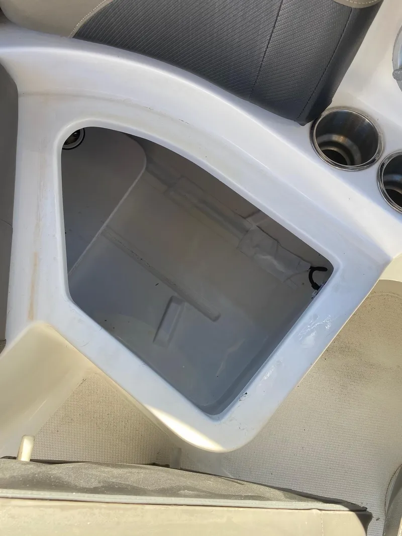 Slide: The Image of 2017 Hurricane SunDeck 2200 DC OB boat storage compartment and cup holders. - 30