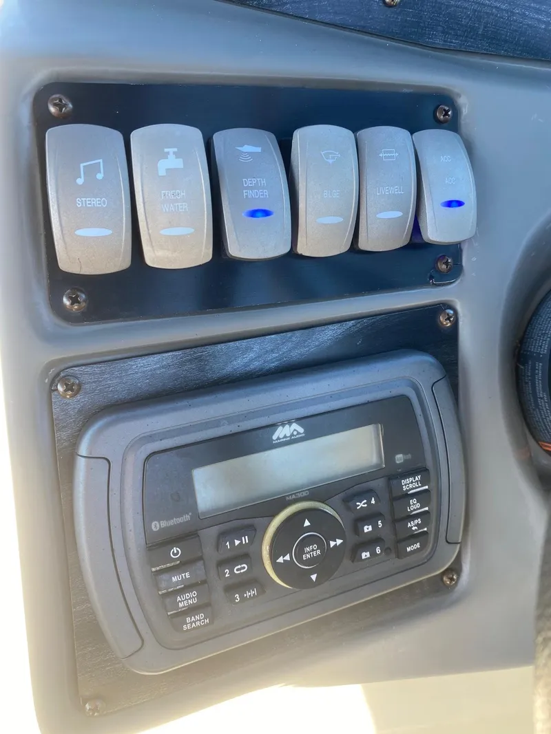 Slide: The Image of Control panel and stereo system of a 2017 Hurricane SunDeck 2200 DC OB boat. - 9