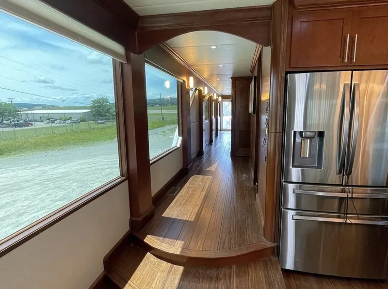 Slide: The Image of Interior of 2015 Stardust Cruisers 20' x 106' houseboat with wooden floors and stainless steel appliances. - 10